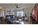 Comfortable living room with a ceiling fan, a large window with a wooded view, and a modern entertainment center at 114 Sunset Point Dr, Ormond Beach, FL 32174
