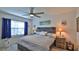Bright main bedroom with a ceiling fan, large window and stylish decor at 114 Sunset Point Dr, Ormond Beach, FL 32174