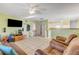 Cozy living room featuring tile flooring, ceiling fan, and an open layout to the kitchen at 118 Orange Ave, Edgewater, FL 32132