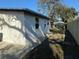 Spacious backyard featuring a side entrance door, new fence, and well-maintained concrete area at 128 Orange Ave, Edgewater, FL 32132
