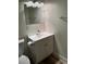 Bathroom with a modern vanity, toilet, and stylish lighting fixtures, showcasing a clean design at 128 Orange Ave, Edgewater, FL 32132