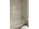 Bathroom featuring tiled walls, a shower head, and a bathtub, perfect for relaxation at 128 Orange Ave, Edgewater, FL 32132