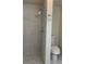 Updated bathroom with modern shower featuring stylish tile work and fixtures, next to a clean, efficient toilet at 128 Orange Ave, Edgewater, FL 32132
