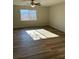 Bright bedroom with laminate wood floors, a ceiling fan and a large window providing natural light at 128 Orange Ave, Edgewater, FL 32132
