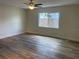 Bright bedroom with a large window, ceiling fan, and wood flooring at 128 Orange Ave, Edgewater, FL 32132