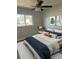 Cozy bedroom with natural light, ceiling fan, and modern furnishings at 128 Orange Ave, Edgewater, FL 32132