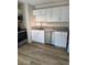 Modern kitchen with stainless steel dishwasher and sink, granite counters, sleek cabinets, and new flooring at 128 Orange Ave, Edgewater, FL 32132