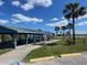Covered community picnic shelter with picnic tables and paved area at 128 Orange Ave, Edgewater, FL 32132