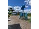 A playground at the community with a pirate ship themed play structure and mature palm trees on a bright day at 128 Orange Ave, Edgewater, FL 32132