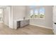 Bright bar area with hardwood floors, white countertop, gray cabinets and views of the green landscape at 13 Arena Blanca, Ponce Inlet, FL 32127