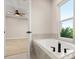 Modern bathroom featuring a luxurious soaking tub with stylish fixtures and a view of the outside at 13 Arena Blanca, Ponce Inlet, FL 32127