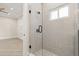 Bathroom with tiled shower, glass door, and pebble flooring at 13 Arena Blanca, Ponce Inlet, FL 32127