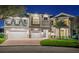 Stunning two-story home with a three-car garage, beautiful stone accents, and a well-manicured lawn at 13 Arena Blanca, Ponce Inlet, FL 32127