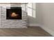 Close-up shot of stone fireplace with hardwood floors, providing a warm and inviting ambiance at 13 Arena Blanca, Ponce Inlet, FL 32127