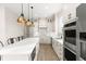 Bright kitchen features an island with seating and stainless steel appliances at 13 Arena Blanca, Ponce Inlet, FL 32127