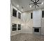 Bright living room with high ceilings featuring a fireplace and a modern ceiling fan at 13 Arena Blanca, Ponce Inlet, FL 32127