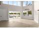Spacious living room boasts high ceilings, large windows, and pool view at 13 Arena Blanca, Ponce Inlet, FL 32127
