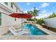Inviting backyard pool area featuring lounge chairs and an umbrella for relaxing poolside at 13 Arena Blanca, Ponce Inlet, FL 32127