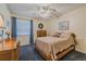 Cozy bedroom featuring carpet, ceiling fan, and a comfortable bed with warm, neutral bedding at 150 Wax Myrtle Woods Ct # 7B, Deltona, FL 32725