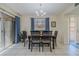 Well-lit dining room featuring a chandelier, a wooden dining table, and sliding glass doors to the outside at 150 Wax Myrtle Woods Ct # 7B, Deltona, FL 32725