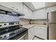 Functional kitchen with stainless steel appliances and white subway tile backsplash at 150 Wax Myrtle Woods Ct # 7B, Deltona, FL 32725