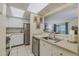 Well-lit kitchen featuring a stainless steel dishwasher and a view into the living room at 150 Wax Myrtle Woods Ct # 7B, Deltona, FL 32725