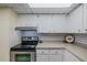 Cozy kitchen with stainless steel appliances and white cabinetry at 150 Wax Myrtle Woods Ct # 7B, Deltona, FL 32725
