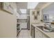 Bright kitchen with white cabinets, stainless steel appliances, and subway tile backsplash at 150 Wax Myrtle Woods Ct # 7B, Deltona, FL 32725