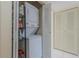 Efficient laundry closet with stacked washer and dryer, plus shelving for storage at 150 Wax Myrtle Woods Ct # 7B, Deltona, FL 32725