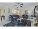 Inviting living room with comfortable seating, stylish decor, and a view into the adjacent kitchen at 150 Wax Myrtle Woods Ct # 7B, Deltona, FL 32725