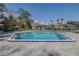 Community pool featuring lounge chairs, umbrellas, and a spacious pool deck for relaxation and enjoyment at 150 Wax Myrtle Woods Ct # 7B, Deltona, FL 32725