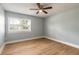 Bedroom with a ceiling fan and large window at 1935 Fern Palm Dr, Edgewater, FL 32141