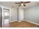 Bedroom featuring wood floors, fresh paint, and a modern ceiling fan at 1935 Fern Palm Dr, Edgewater, FL 32141