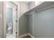 Walk-in closet with storage shelf and interior view of attached bathroom at 1935 Fern Palm Dr, Edgewater, FL 32141