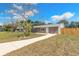 Well-maintained home featuring neutral stucco, white trim, and an elongated walkway to the front entrance at 1935 Fern Palm Dr, Edgewater, FL 32141
