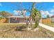 Charming single-story home featuring neutral stucco, white trim, and a tidy front yard with simple landscaping at 1935 Fern Palm Dr, Edgewater, FL 32141