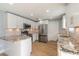 Modern kitchen featuring stainless appliances, stone countertops, new cabinets, and an open layout at 1935 Fern Palm Dr, Edgewater, FL 32141