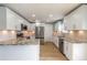 Bright kitchen featuring white cabinets, granite countertops, stainless steel appliances and light wood flooring at 1935 Fern Palm Dr, Edgewater, FL 32141