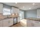 Well-lit kitchen with stainless appliances, white cabinets, granite counters, and sliding glass doors to the outside at 1935 Fern Palm Dr, Edgewater, FL 32141