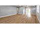 Spacious living room with new floors, fresh paint, and an open layout leading to the kitchen at 1935 Fern Palm Dr, Edgewater, FL 32141