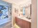 Bathroom with a modern vanity, mirrored wall, and decorative light fixture at 231 Riverside Dr # 1509-1, Holly Hill, FL 32117