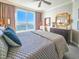 Bedroom featuring an upholstered headboard, ceiling fan, and waterfront view at 231 Riverside Dr # 1509-1, Holly Hill, FL 32117