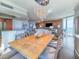 Open-concept dining area featuring a decorative chandelier, wood table, and views into the living room and kitchen at 231 Riverside Dr # 1509-1, Holly Hill, FL 32117