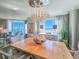 Sunlit dining room with a decorative chandelier, large windows offering stunning water views, and stylish decor at 231 Riverside Dr # 1509-1, Holly Hill, FL 32117