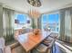 Bright dining room showcasing a large wooden table, decorative chandelier, and expansive windows with scenic views at 231 Riverside Dr # 1509-1, Holly Hill, FL 32117