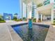 Elegant entrance with a tranquil fountain and lush landscaping, offering a welcoming atmosphere at 231 Riverside Dr # 1509-1, Holly Hill, FL 32117