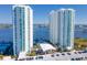 Stunning aerial view of two modern high-rise condo buildings with blue balconies overlooking the water at 231 Riverside Dr # 1509-1, Holly Hill, FL 32117