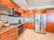 Sleek kitchen featuring modern wood cabinets, stainless steel appliances, and ample counter space for cooking and entertaining at 231 Riverside Dr # 1509-1, Holly Hill, FL 32117