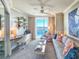 Cozy living room with a desk area, comfortable seating, and a view of the water at 231 Riverside Dr # 1509-1, Holly Hill, FL 32117