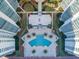 Aerial view of a beautifully landscaped pool area nestled between modern condo buildings at 231 Riverside Dr # 1509-1, Holly Hill, FL 32117
